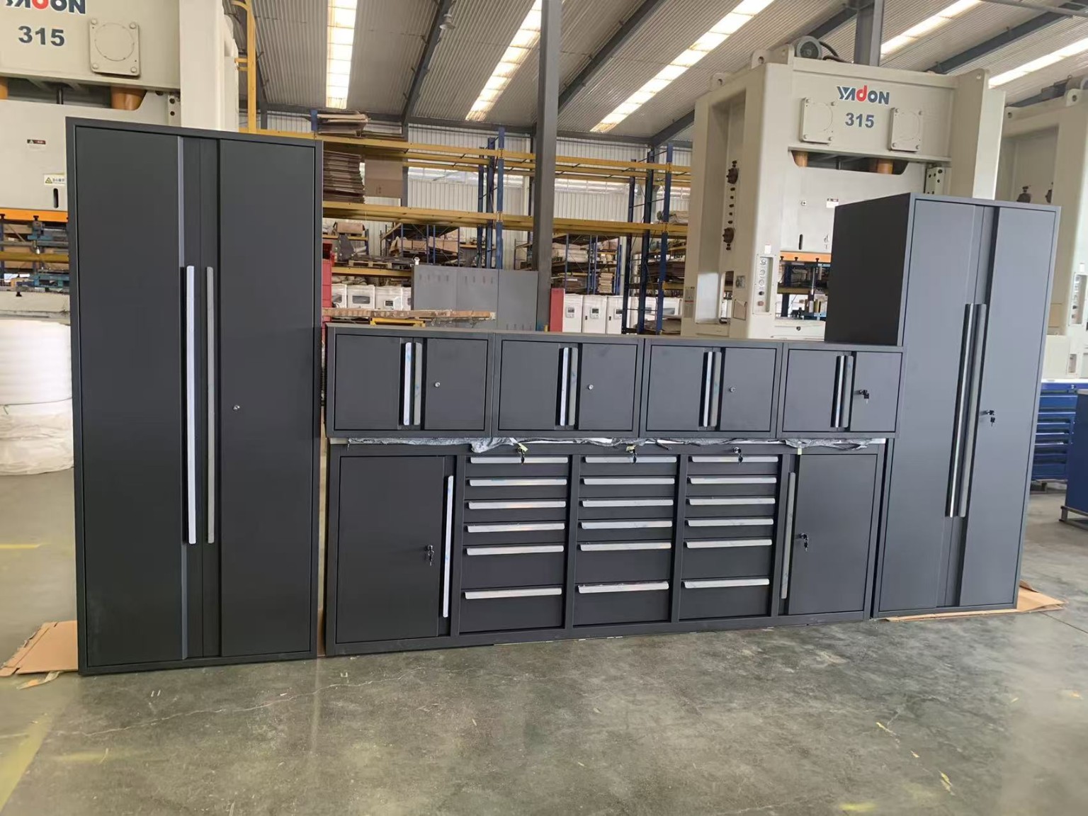 Dark gray modular workshop cabinet system with tall side cabinets