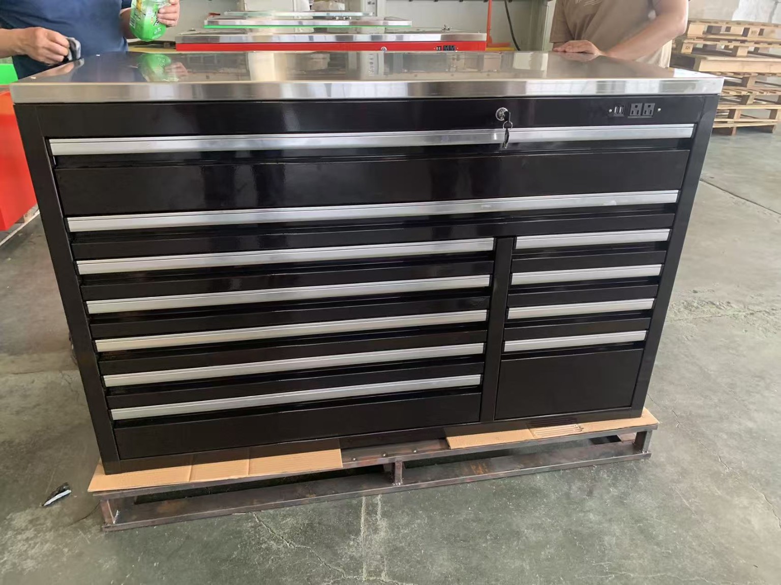 Black multi-drawer tool chest with stainless worktop and power outlets